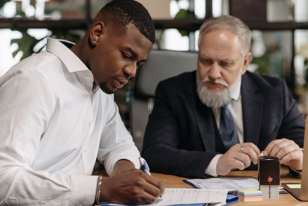 Two men reviewing paperwork at a desk