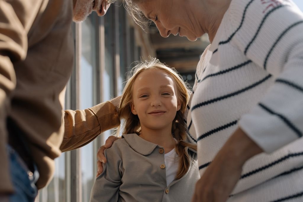 Family unpacking boxes with a young child