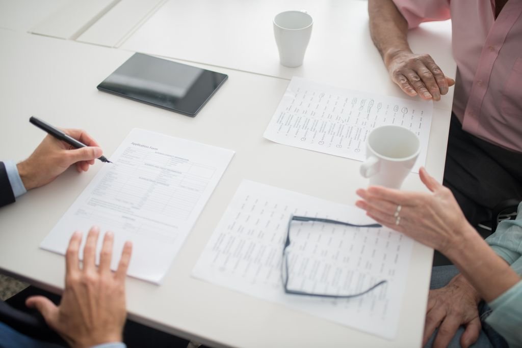 People reviewing paperwork around a table