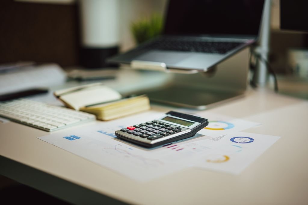 Is EBIT the Same as Operating Income? How to Read the Difference Calculator and charts on a desk beside a laptop