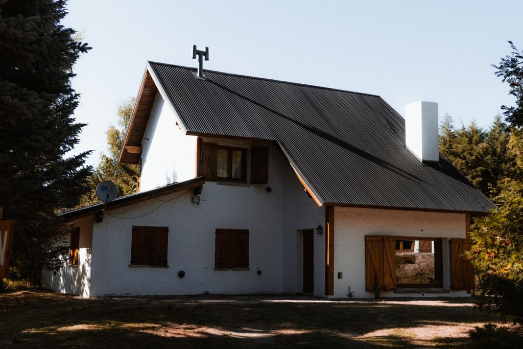 Home Insurance Dwelling Coverage: What Does Coverage A Protect? White house with a dark pitched roof