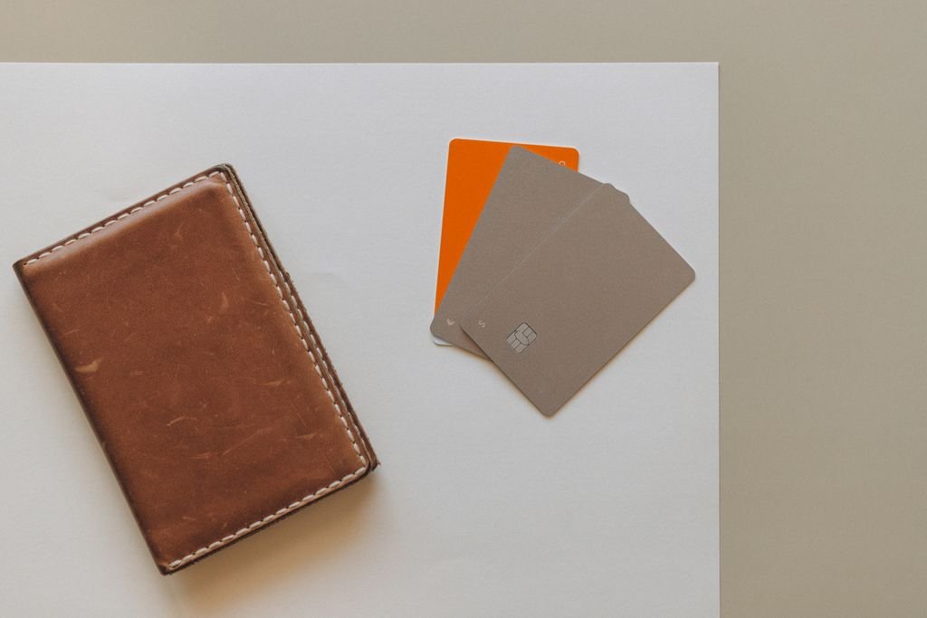 Credit Balance Refund: How to Get Your Credit Card Overpayment Back Brown leather wallet beside bank cards on a light surface