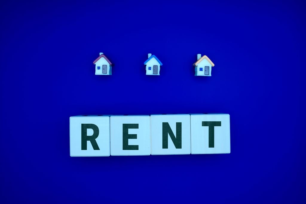 Tiles spelling Rent beneath three small house icons
