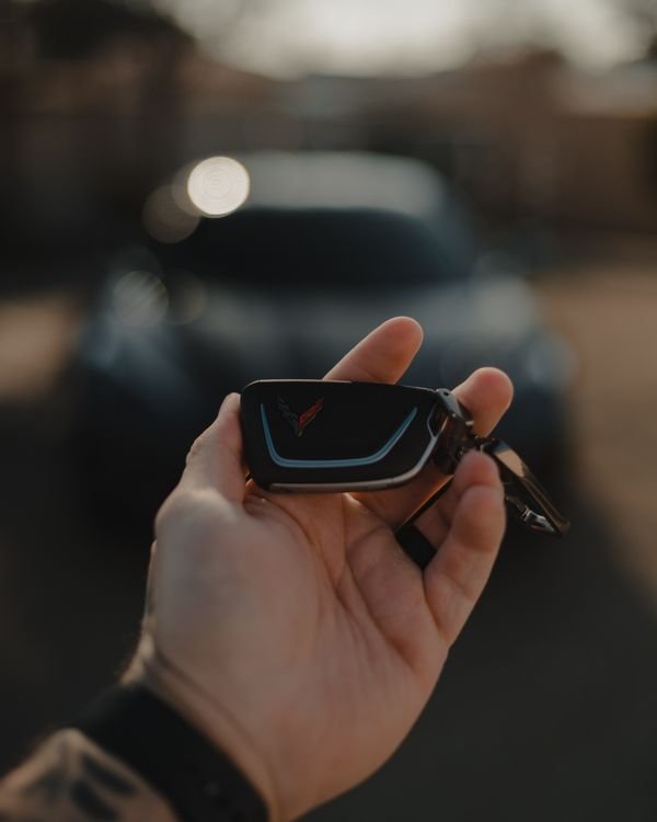 Hand holding a car key fob