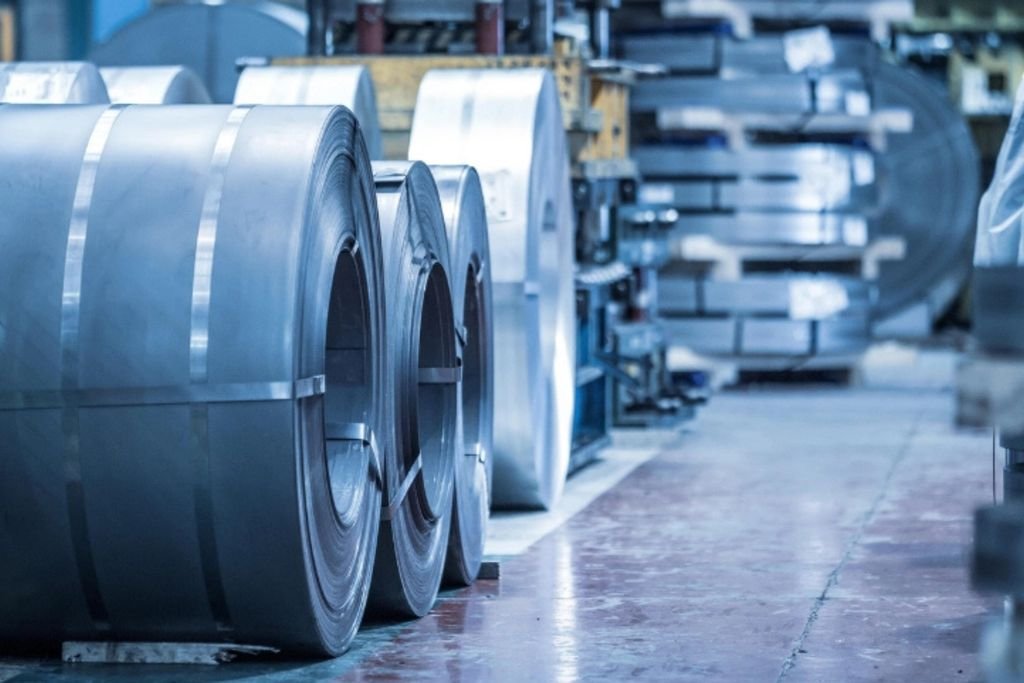 Close-up of coiled metal sheets in an industrial factory. Precision engineering materials.