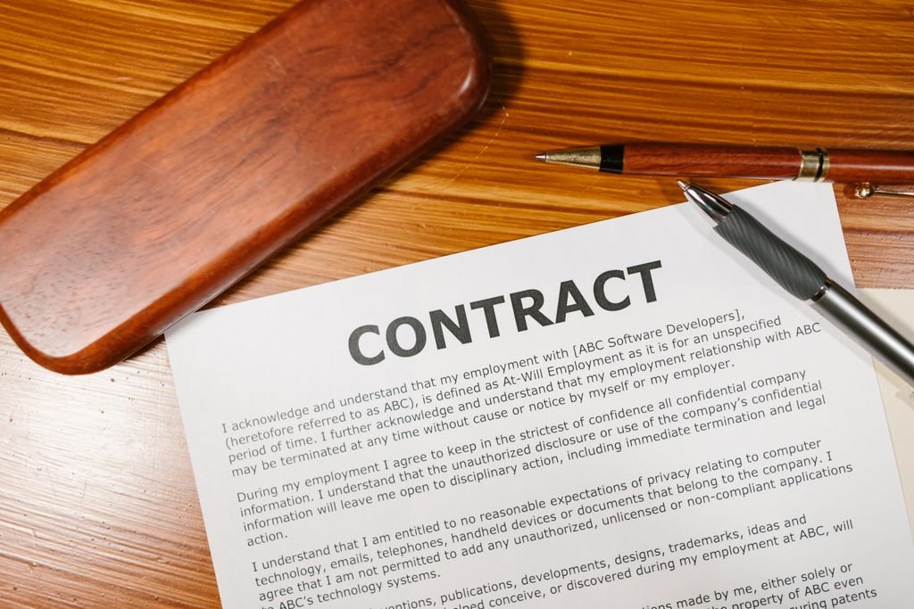 Waiver of Subrogation: Meaning, Examples and How It Works Contract and pen on a wooden desk