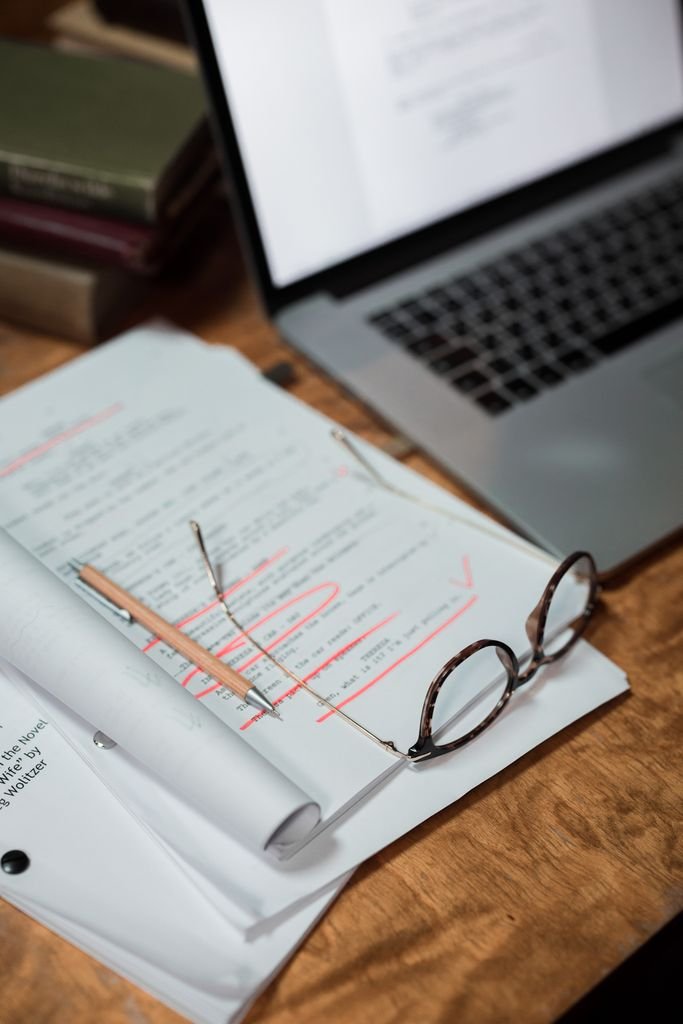 Joint Accounts After Death: 5 Steps for Surviving Owners Glasses on financial paperwork beside a laptop