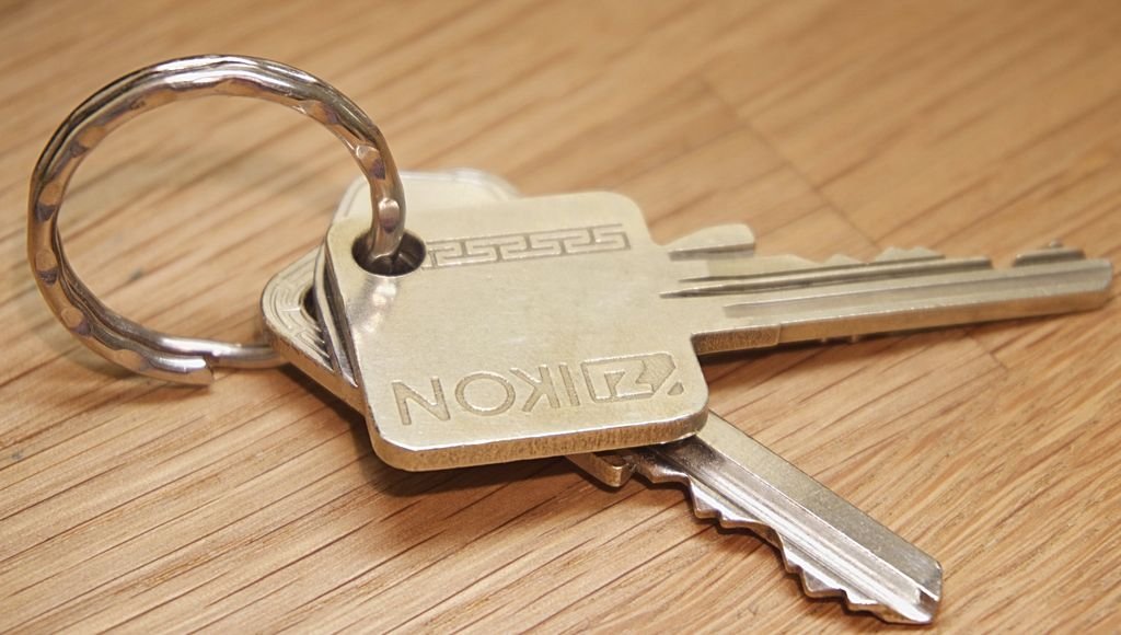 Metal house keys on a wooden surface illustrating renters insurance coverage