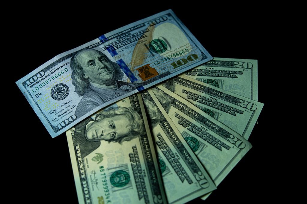 Treasury STRIPS: How They Work, Taxes and Investment Risks US dollar banknotes arranged on a black background