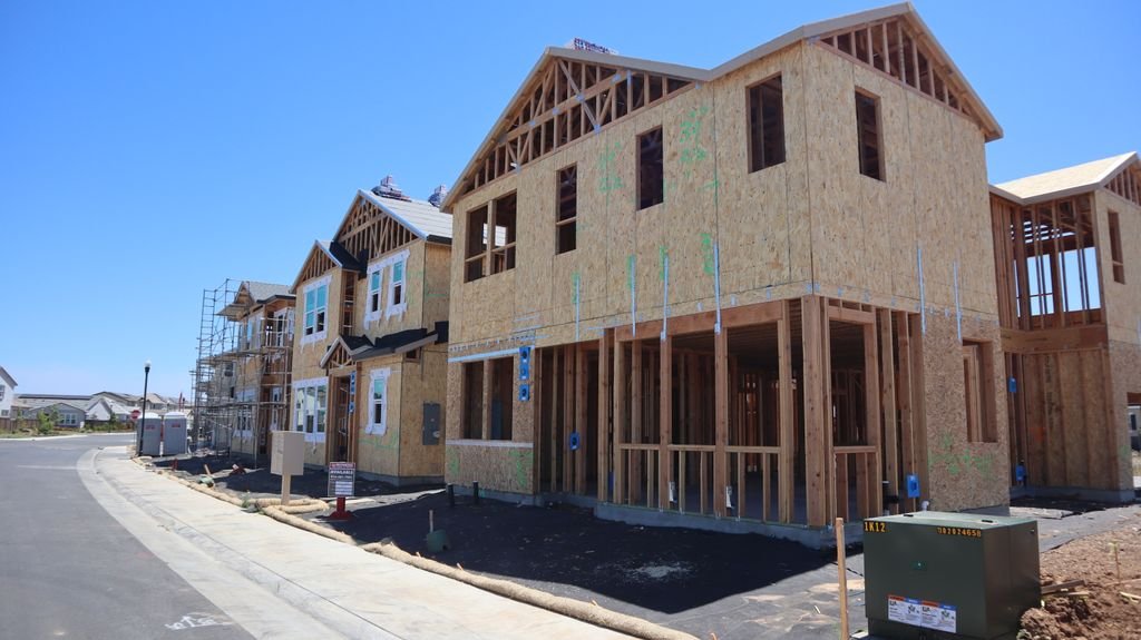 Wood-framed homes under construction illustrating home rebuilding costs